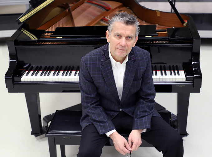 Edward Gnandt sitting at a piano